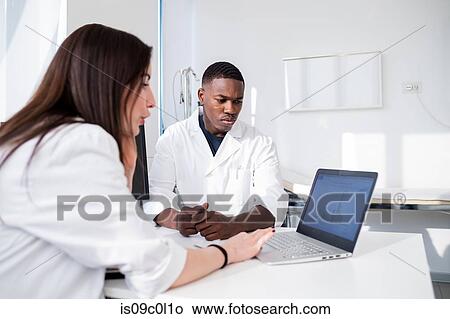 Picture - Doctors having discussion in meeting room. Fotosearch