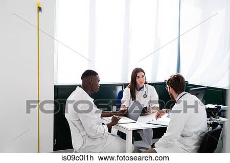 Doctors having discussion in meeting room View Large Photo Image Stock Image - Doctors having discussion in meeting room. Fotosearch