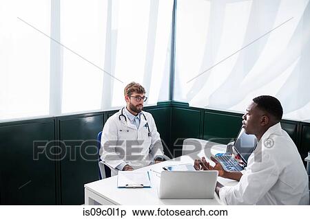 Doctors having discussion in meeting room View Large Photo Image Stock Photography - Doctors having discussion in meeting room. Fotosearch