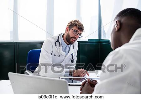 Doctors having discussion in meeting room View Large Photo Image Stock Photography - Doctors having discussion in meeting room. Fotosearch