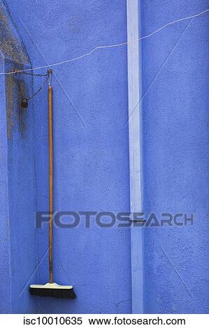 Drain and broom locked with chain on blue stucco exterior house wall, Burano Island, Venetian Lagoon, Venice, Veneto, Italy View Large Photo Image Stock Photography - Drain and broom locked with chain on blue stucco exterior house wall, Burano Island, Venetian Lagoon, Venice, Veneto, Italy. Fotosearch