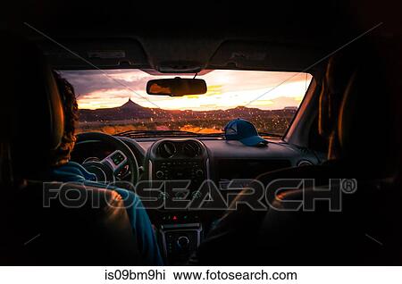 Driver and friend in car watching sunset, Indian Creek, Moab, Utah, USA View Large Photo Image Stock Image - Driver and friend in car watching sunset, Indian Creek, Moab, Utah, USA. Fotosearch