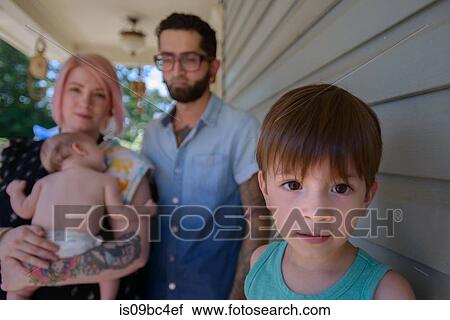 Stock Image - Family in front porch of house. Fotosearch