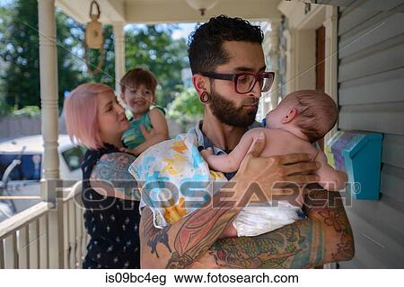 Family in front porch of house View Large Photo Image Stock Image - Family in front porch of house. Fotosearch