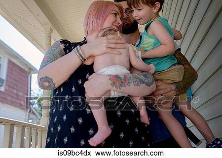 Stock Photo - Family in front porch of house. Fotosearch
