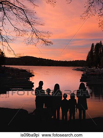 Stock Image - Family looking out at Lake Arrowhead, California, USA. Fotosearch