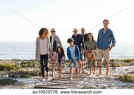Family of eight taking walk on beach View Large Photo Image Stock Photograph - Family of eight taking walk on beach. Fotosearch