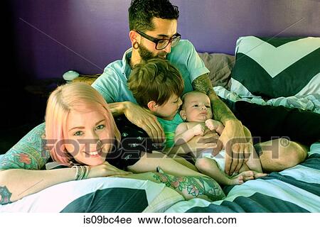 Family on bed in bedroom View Large Photo Image Stock Image - Family on bed in bedroom. Fotosearch