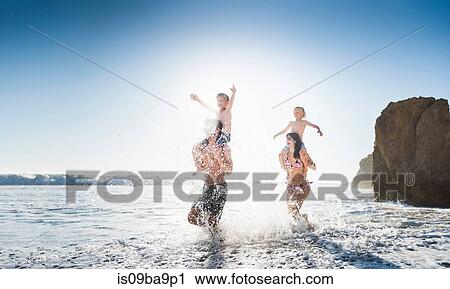 Stock Image - Family playing on El Matador Beach, Malibu, USA. Fotosearch