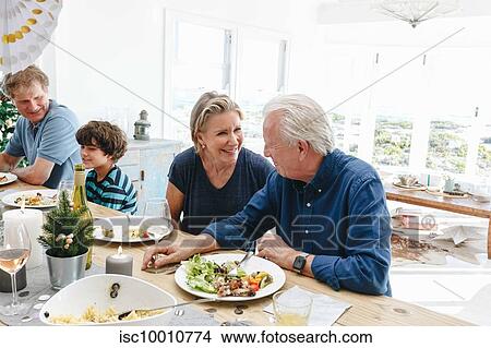 Picture - Family talking and bonding at home party. Fotosearch