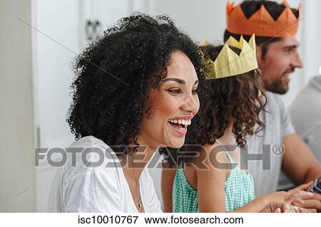 Stock Photo - Family talking and bonding at home party. Fotosearch