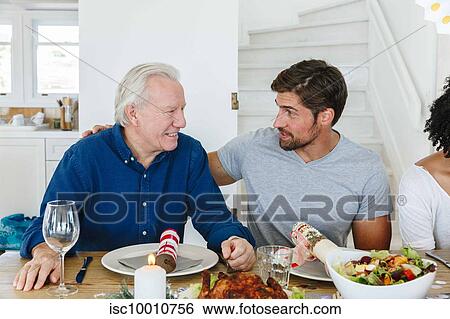 Family talking and bonding at home party View Large Photo Image Stock Photograph - Family talking and bonding at home party. Fotosearch