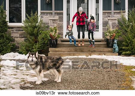 Stock Photography - Family with pet dog leaving house to go out. Fotosearch
