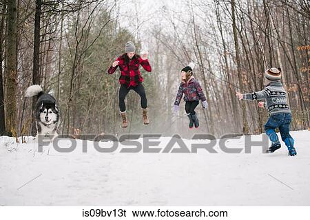 Family with pet dog playing in snow landscape View Large Photo Image Stock Photograph - Family with pet dog playing in snow landscape. Fotosearch
