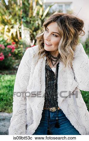 Stock Image - Fashionable woman in fake fur coat. Fotosearch