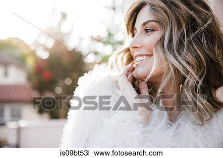 Stock Image - Fashionable woman in fake fur coat. Fotosearch