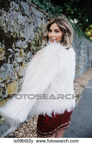 Fashionable woman walking along old stone wall, San Rafael, California, US View Large Photo Image Stock Photo - Fashionable woman walking along old stone wall, San Rafael, California, US. Fotosearch