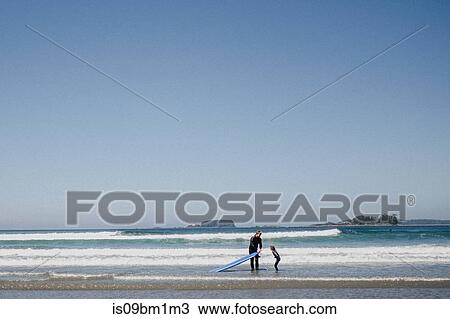 Father and child surfing on beach, Tofino, Canada View Large Photo Image Stock Image - Father and child surfing on beach, Tofino, Canada. Fotosearch