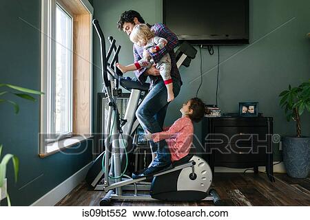 Father and children playing on elliptical machine View Large Photo Image Stock Image - Father and children playing on elliptical machine. Fotosearch
