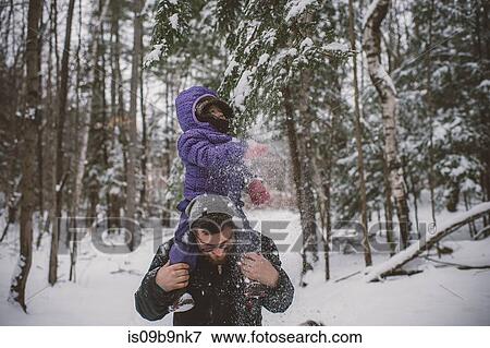 Father and daughter in snowy landscape, father carrying daughter on shoulders View Large Photo Image Stock Photo - Father and daughter in snowy landscape, father carrying daughter on shoulders. Fotosearch