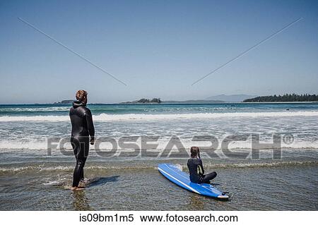 Father and daughter surfing on beach, Tofino, Canada View Large Photo Image Stock Photography - Father and daughter surfing on beach, Tofino, Canada. Fotosearch