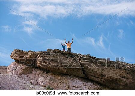 Father and son rejoicing on peak, Red Rock Canyon, Cantil, California, United States View Large Photo Image Stock Image - Father and son rejoicing on peak, Red Rock Canyon, Cantil, California, United States. Fotosearch