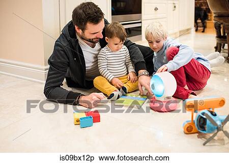 Father and sons playing with toys on floor View Large Photo Image Stock Photography - Father and sons playing with toys on floor. Fotosearch