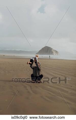 Father and toddler playing on beach, Morro Bay, California, United States View Large Photo Image Stock Image - Father and toddler playing on beach, Morro Bay, California, United States. Fotosearch