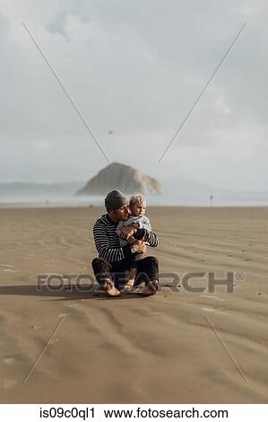 Father and toddler sitting on beach, Morro Bay, California, United States View Large Photo Image Stock Image - Father and toddler sitting on beach, Morro Bay, California, United States. Fotosearch