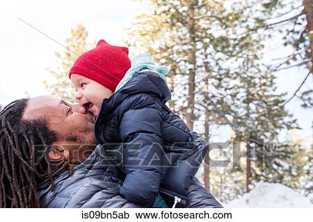 Father face to face with baby son in winter forest, South Lake Tahoe, California, USA View Large Photo Image Stock Image - Father face to face with baby son in winter forest, South Lake Tahoe, California, USA. Fotosearch