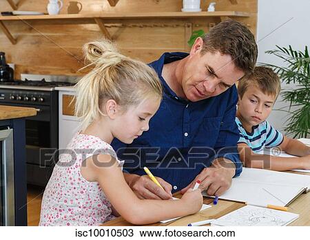 Father helping children with homework at home View Large Photo Image Stock Image - Father helping children with homework at home. Fotosearch