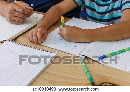 Father helping son with homework at home View Large Photo Image Stock Image - Father helping son with homework at home. Fotosearch