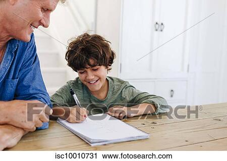 Father helping son with homework at home View Large Photo Image Stock Image - Father helping son with homework at home. Fotosearch