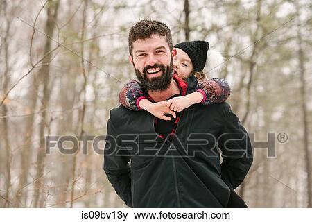 Father piggybacking daughter in forest View Large Photo Image Stock Photo - Father piggybacking daughter in forest. Fotosearch