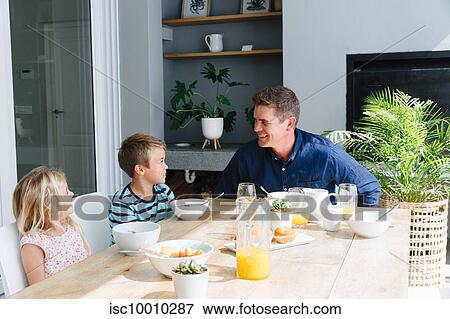 Father talking with children during lunch at home View Large Photo Image Stock Photo - Father talking with children during lunch at home. Fotosearch