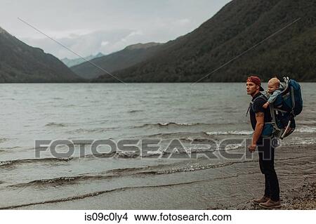 Picture - Father with baby on beach, Queenstown, Canterbury, New Zealand. Fotosearch