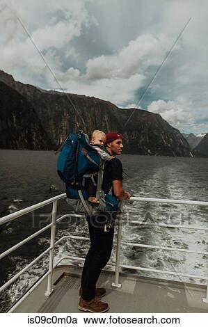 Stock Image - Father with baby on lake cruise, Queenstown, Canterbury, New Zealand. Fotosearch