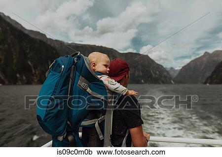 Stock Image - Father with baby on lake cruise, Queenstown, Canterbury, New Zealand. Fotosearch