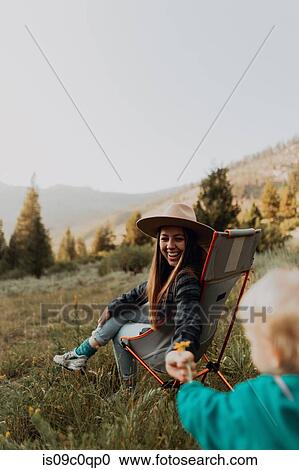 Female toddler handing flower to young woman in rural valley, cropped, Mineral King, California, USA View Large Photo Image Stock Image - Female toddler handing flower to young woman in rural valley, cropped, Mineral King, California, USA. Fotosearch
