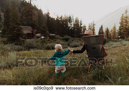 Female toddler handing flower to young woman in rural valley, Mineral King, California, USA View Large Photo Image Stock Photo - Female toddler handing flower to young woman in rural valley, Mineral King, California, USA. Fotosearch