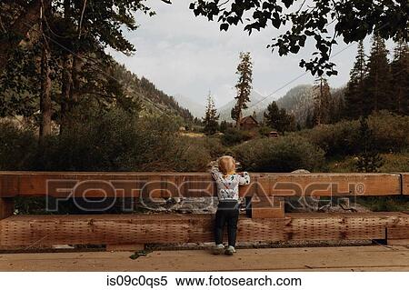 Female toddler looking out at river from rural bridge, rear view, Mineral King, California, USA View Large Photo Image Stock Photography - Female toddler looking out at river from rural bridge, rear view, Mineral King, California, USA. Fotosearch