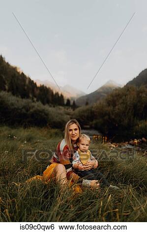 Female toddler sitting on mother's lap by rural river, portrait, Mineral King, California, USA View Large Photo Image Stock Photograph - Female toddler sitting on mother's lap by rural river, portrait, Mineral King, California, USA. Fotosearch