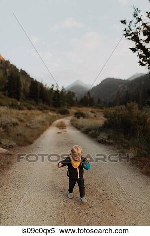 Female toddler toddling along rural road, Mineral King, California, USA View Large Photo Image Stock Photography - Female toddler toddling along rural road, Mineral King, California, USA. Fotosearch