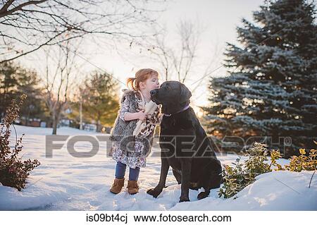 Female toddler with red hair playing in snow with dog, Keene, Ontario, Canada View Large Photo Image Stock Image - Female toddler with red hair playing in snow with dog, Keene, Ontario, Canada. Fotosearch