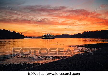 Stock Image - Ferry on Puget Sound at sunset, Bainbridge, Washington, United States. Fotosearch