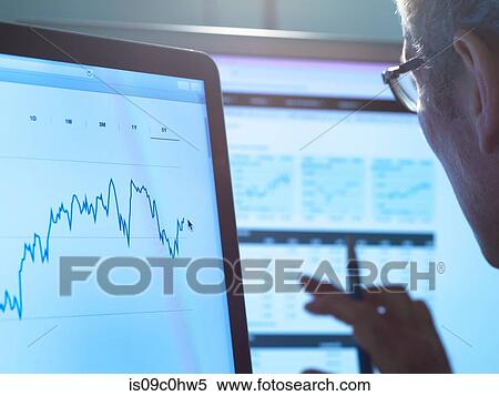 Stock Photography - Financial services, stock analyst researching share price data of a company on the computer. Fotosearch