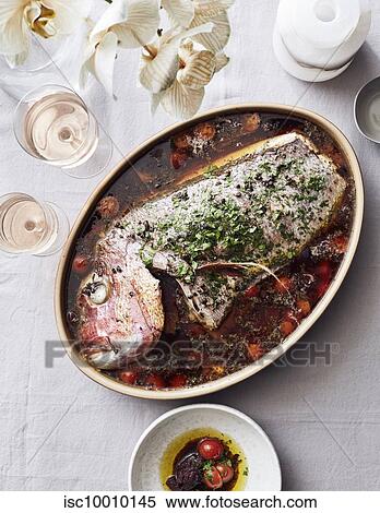 Fish cooked in tomatoes served with rose wine View Large Photo Image Stock Photography - Fish cooked in tomatoes served with rose wine. Fotosearch