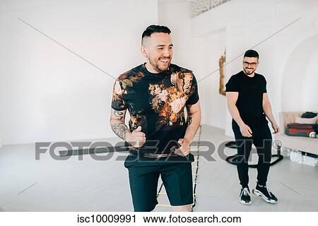 Fitness instructor and friend taking break in studio View Large Photo Image Stock Image - Fitness instructor and friend taking break in studio. Fotosearch