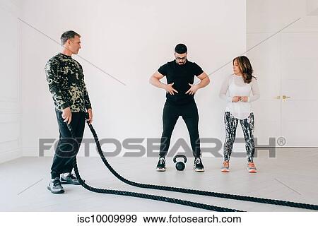 Fitness instructor showing woman core exercise in studio View Large Photo Image Stock Photo - Fitness instructor showing woman core exercise in studio. Fotosearch