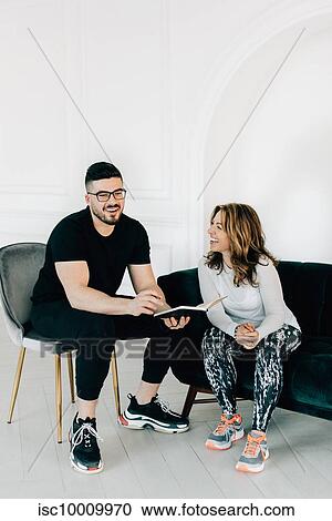 Fitness instructor talking to woman in studio View Large Photo Image Stock Image - Fitness instructor talking to woman in studio. Fotosearch